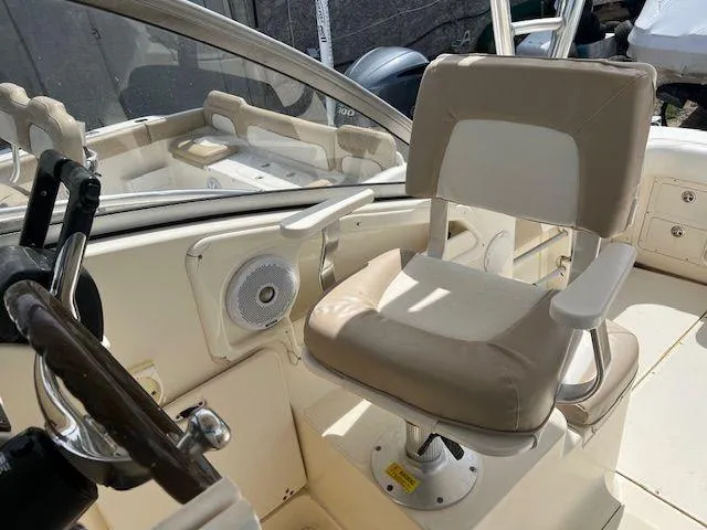 Slide: The Image of Captain's chair on 2006 Scout 262 Abaco boat, featuring beige upholstery and steering wheel. - 13