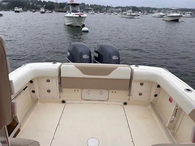 Slide: The Image of 2006 Scout 262 Abaco boat with twin 150 engines, docked in a scenic harbor. - 17