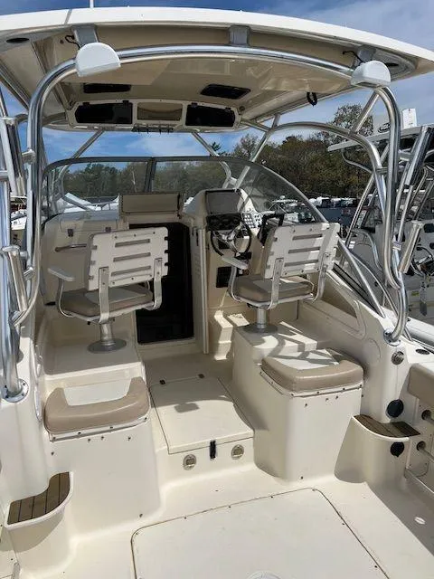 Slide: The Image of 2006 Scout 262 Abaco boat interior with seating and steering console. - 19