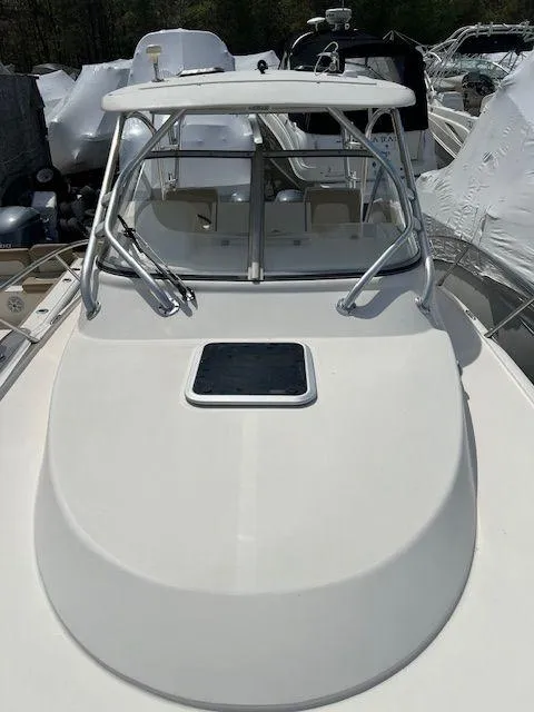 Slide: The Image of 2006 Scout 262 Abaco boat with sleek design and windshield, docked among other vessels. - 20