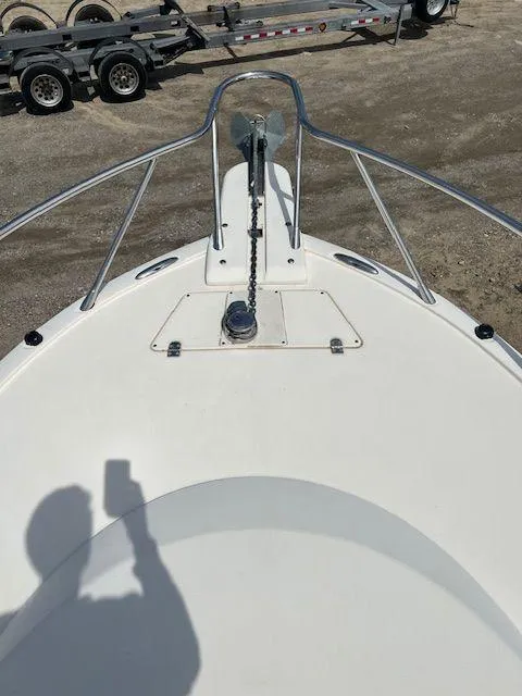 Slide: The Image of 2006 Scout 262 Abaco boat bow with anchor and railing, shadow visible. - 21