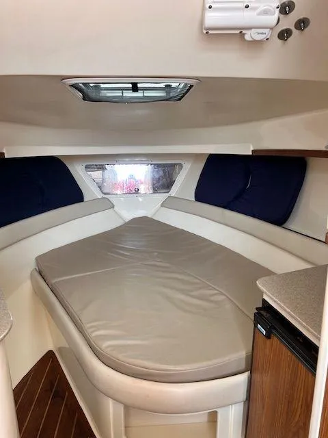 Slide: The Image of 2006 Scout 262 Abaco cabin interior with cushioned seating and wooden accents. - 23