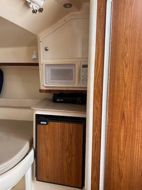Slide: The Image of 2006 Scout 262 Abaco cabin interior with microwave and mini fridge. - 25
