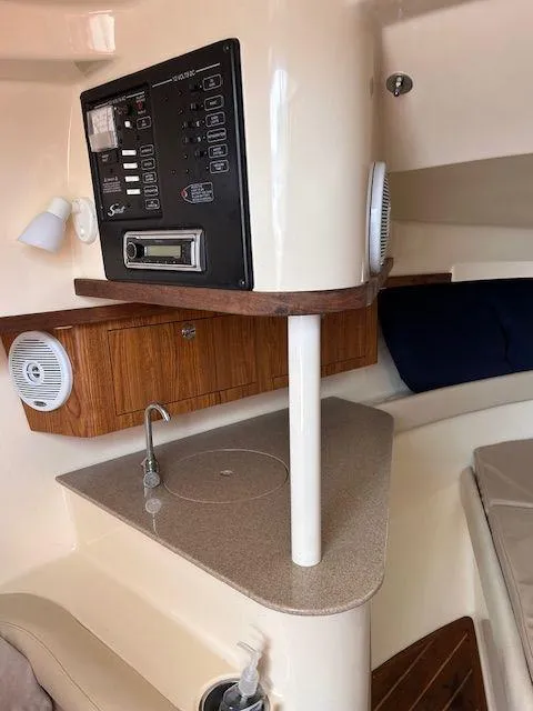 Slide: The Image of 2006 Scout 262 Abaco boat interior with control panel and compact kitchenette. - 27