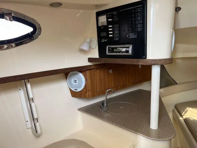 Slide: The Image of 2006 Scout 262 Abaco cabin interior with control panel and compact kitchenette. - 28