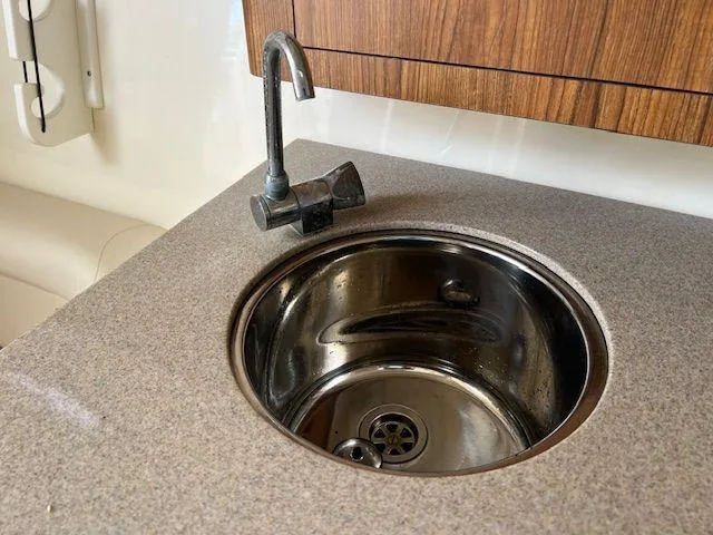 Slide: The Image of Compact sink and faucet in 2006 Scout 262 Abaco boat interior. - 29