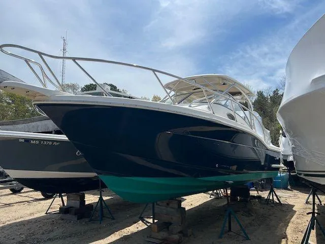 Slide: The Image of 2006 Scout 262 Abaco boat on stands, blue hull, outdoor storage. - 3