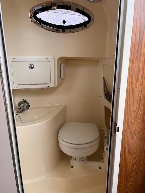 Slide: The Image of 2006 Scout 262 Abaco boat bathroom with toilet, sink, and storage compartment. - 30
