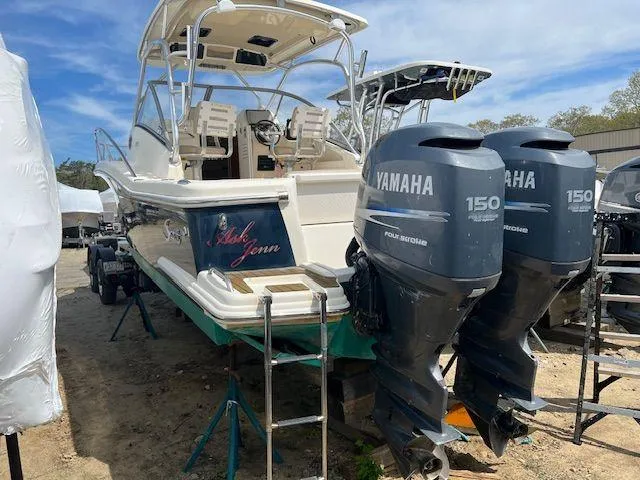 Slide: The Image of 2006 Scout 262 Abaco boat with twin Yamaha 150 engines, docked on land. - 5