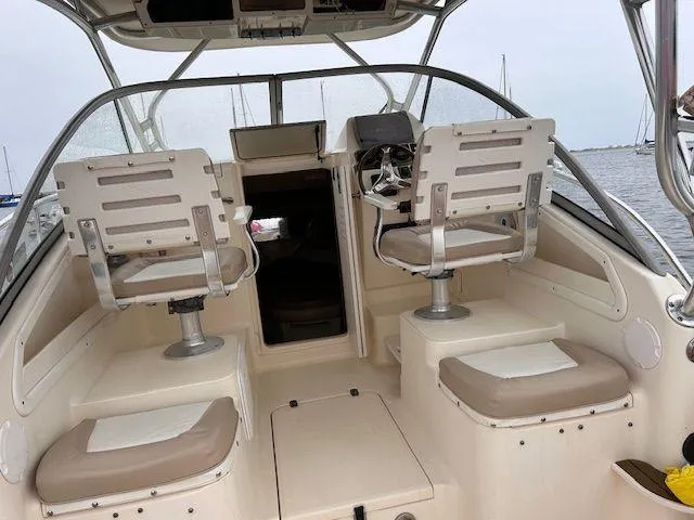 Slide: The Image of 2006 Scout 262 Abaco boat interior with dual helm seats and open cabin entrance. - 6