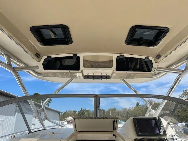 Slide: The Image of 2006 Scout 262 Abaco boat interior with overhead storage and navigation equipment. - 7