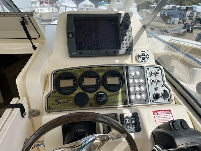 Slide: The Image of 2006 Scout 262 Abaco boat dashboard with navigation controls and display screen. - 9