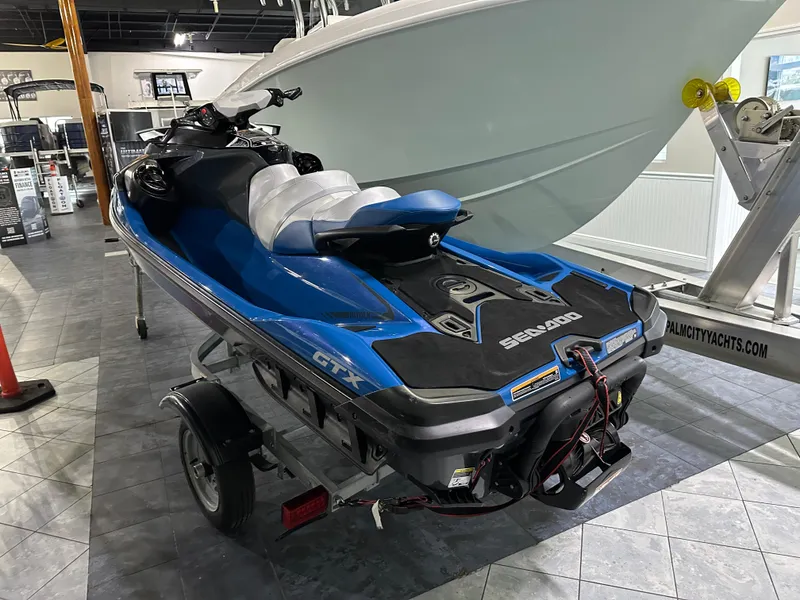 Slide: The Image of 2021 Sea-Doo GTX 170 jet ski on trailer in showroom. - 4