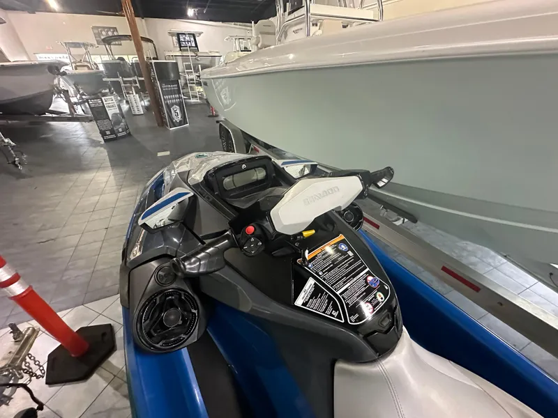 Slide: The Image of 2021 Sea-Doo GTX 170 jet ski displayed indoors, showcasing handlebars and seating. - 5