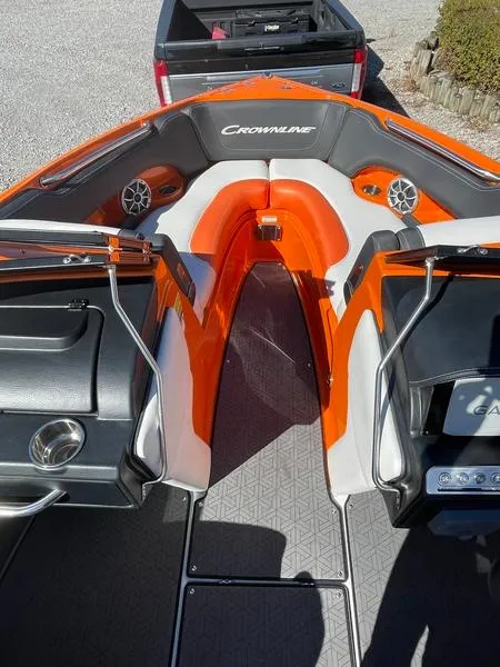 Slide: The Image of 2023 Crownline 220 SS LPX boat interior with orange and gray seating, speakers, and sleek design. - 5