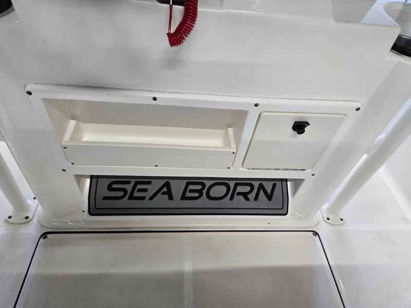Slide: The Image of 2021 Sea Born LX22 Center Console boat interior with storage compartment and logo. - 21