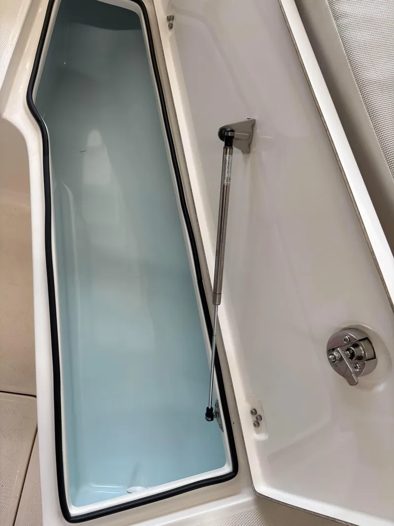 Slide: The Image of 2021 Sea Born LX22 Center Console storage compartment with hydraulic lift. - 22