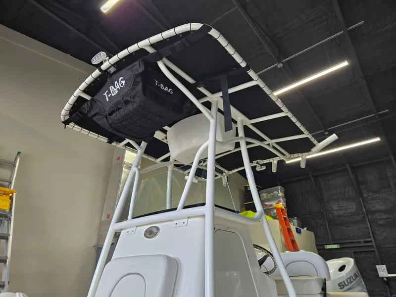 Slide: The Image of 2021 Sea Born LX22 Center Console boat with T-top and storage bag in a garage. - 23