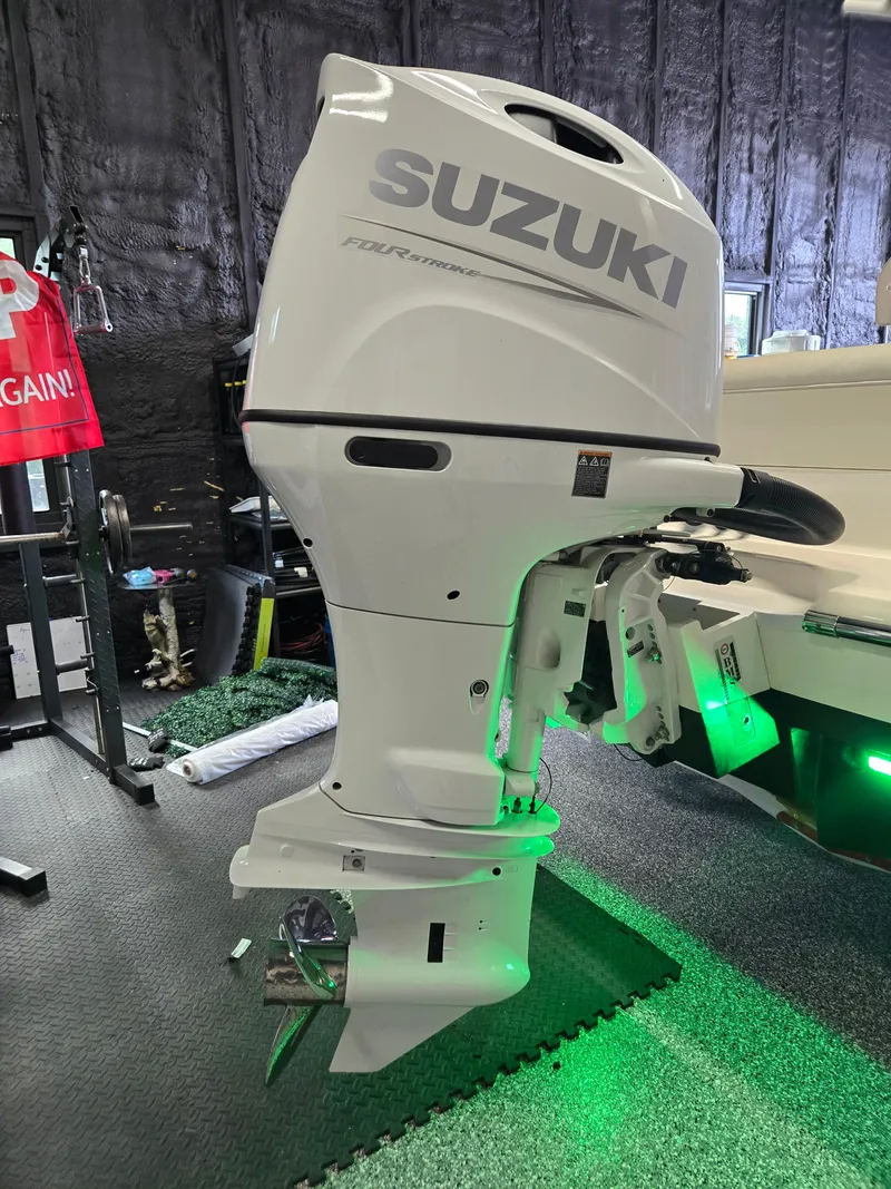 Slide: The Image of 2021 Sea Born LX22 Center Console with Suzuki outboard motor in a showroom. - 3