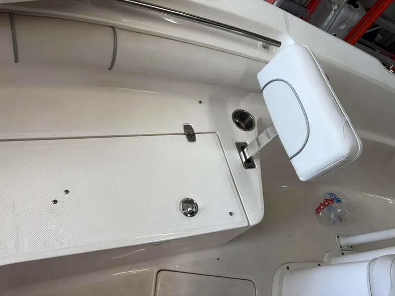 Slide: The Image of 2021 Sea Born LX22 Center Console boat interior with white seating and storage compartment. - 33