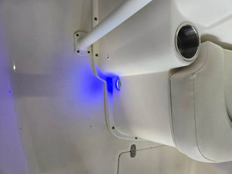 Slide: The Image of 2021 Sea Born LX22 Center Console interior with blue LED lighting and cup holder. - 34