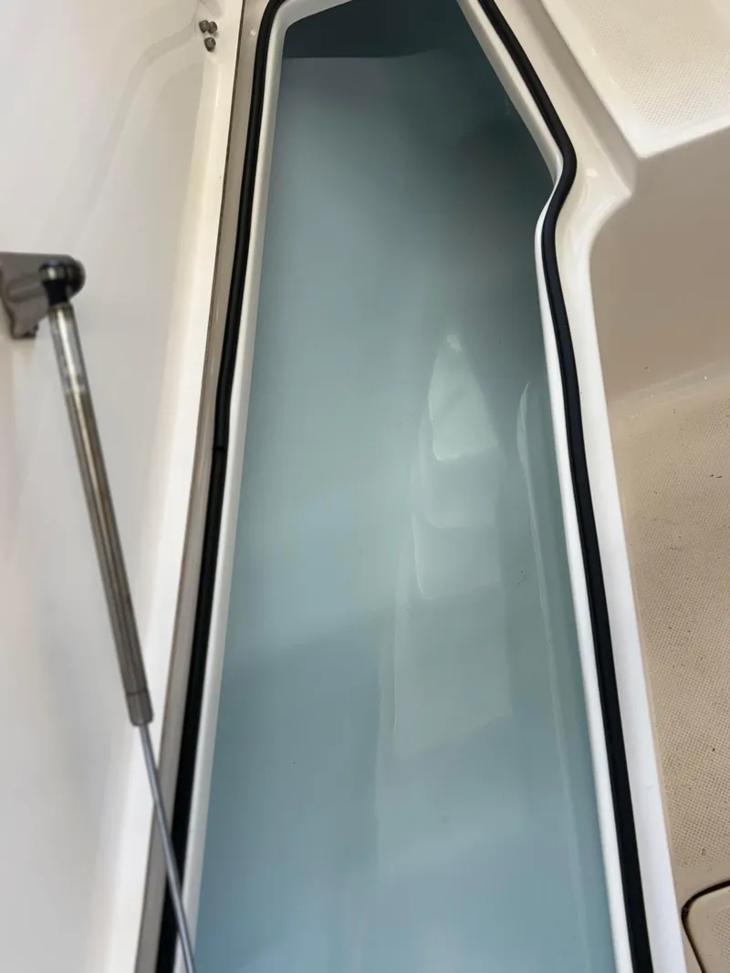 Slide: The Image of 2021 Sea Born LX22 Center Console storage compartment with hydraulic support. - 42