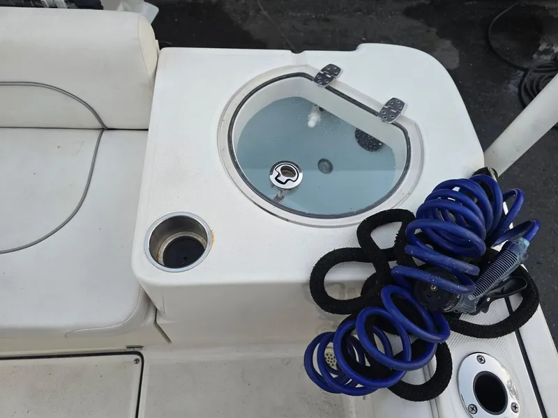 Slide: The Image of 2021 Sea Born LX22 Center Console boat with livewell and coiled blue hose. - 47