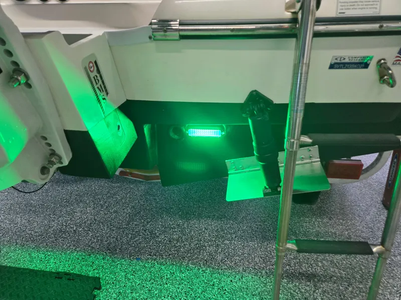 Slide: The Image of 2021 Sea Born LX22 Center Console boat with green underwater lights and ladder. - 7