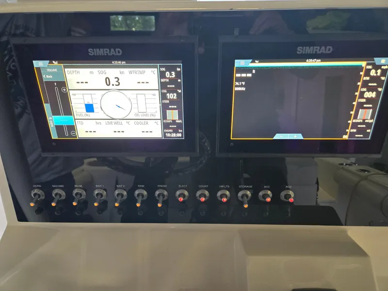 Slide: The Image of Simrad navigation displays on 2021 Sea Born LX22 Center Console boat dashboard. - 9