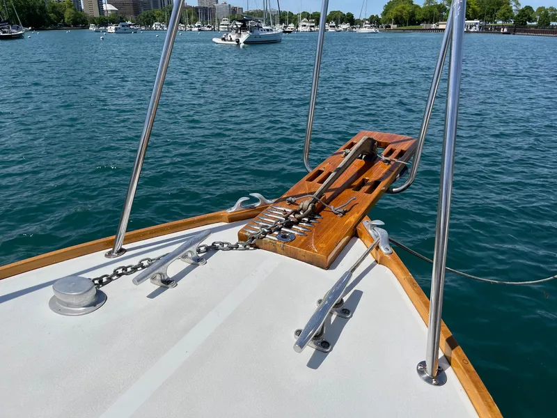 Slide: The Image of 1986 Dyer 29 Trunk Cabin boat deck with anchor, on calm water. - 10