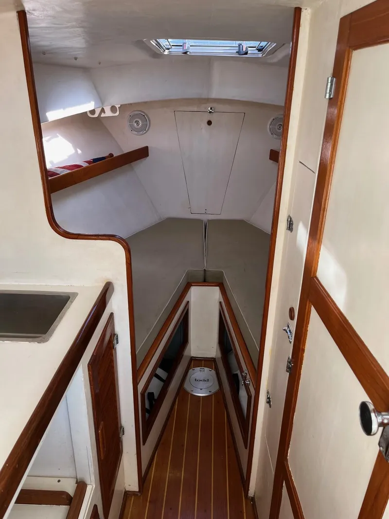 Slide: The Image of 1986 Dyer 29 Trunk Cabin interior with wood accents and compact layout. - 11