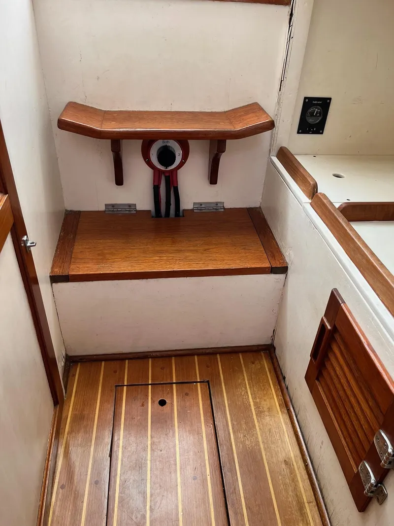 Slide: The Image of 1986 Dyer 29 Trunk Cabin interior with wooden flooring and seating area. - 14