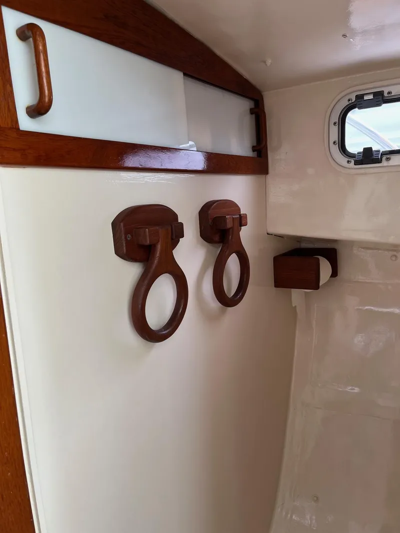 Slide: The Image of Interior of 1986 Dyer 29 Trunk Cabin with wooden hooks and porthole. - 16