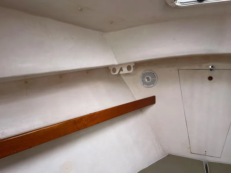 Slide: The Image of Interior of 1986 Dyer 29 Trunk Cabin, featuring wooden trim and storage compartment. - 19