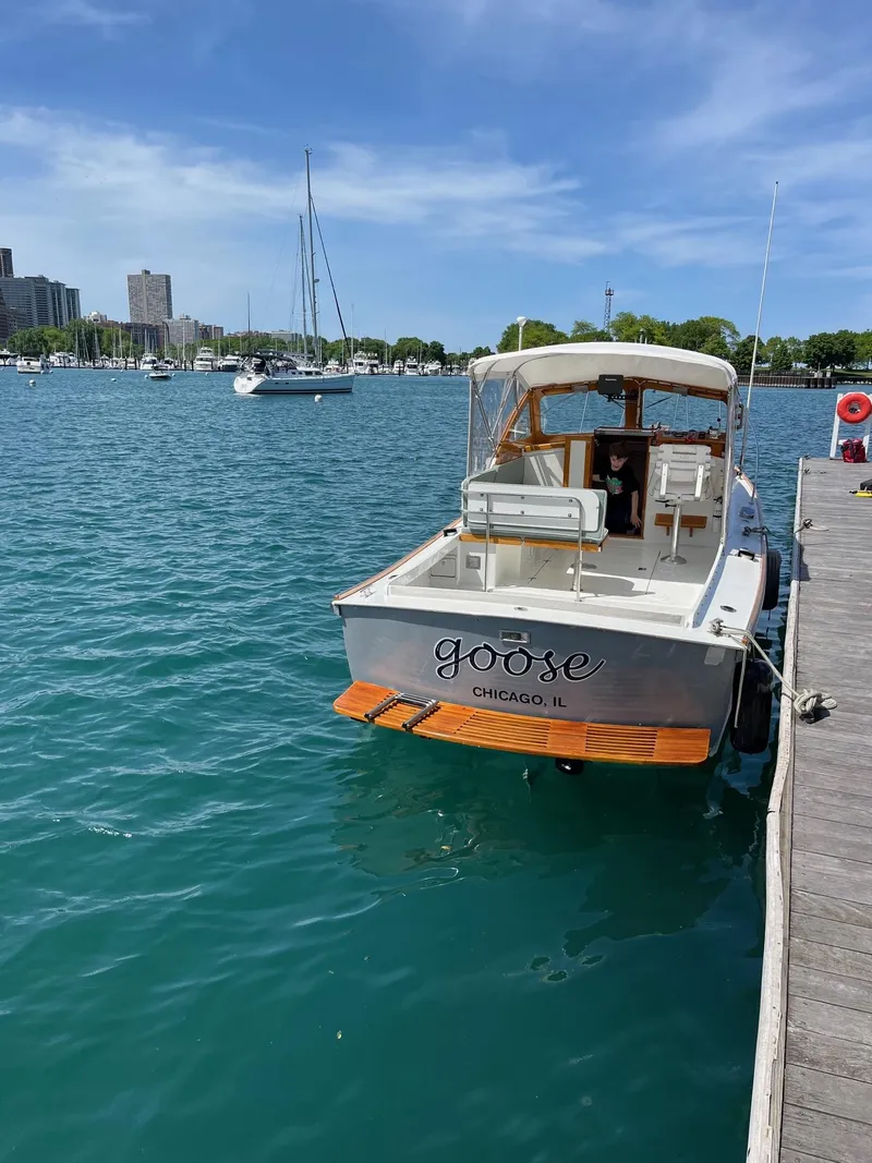 Slide: The Image of 1986 Dyer 29 Trunk Cabin boat docked in sunny marina, Chicago. - 2