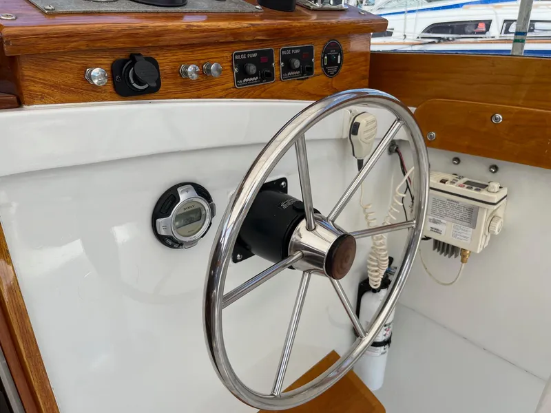 Slide: The Image of Steering wheel and controls of a 1986 Dyer 29 Trunk Cabin boat. - 23
