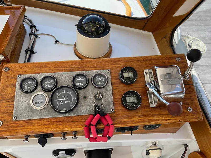 Slide: The Image of 1986 Dyer 29 Trunk Cabin dashboard with gauges, compass, and controls. - 24