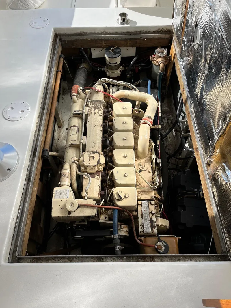 Slide: The Image of Engine compartment of a 1986 Dyer 29 Trunk Cabin boat, showcasing detailed mechanical components. - 27
