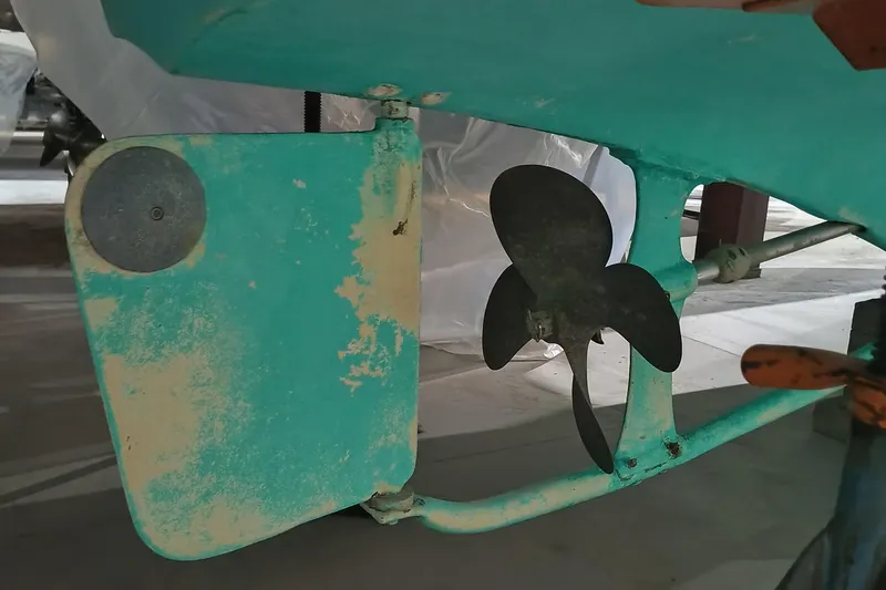 Slide: The Image of Propeller and rudder of a 1986 Dyer 29 Trunk Cabin boat, showing wear and teal paint. - 28