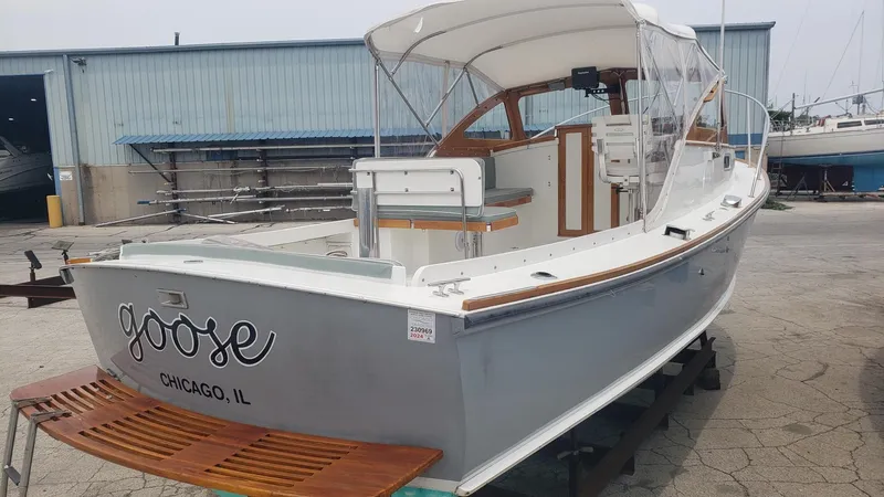 Slide: The Image of 1986 Dyer 29 Trunk Cabin boat named "Goose" in a marina setting. - 29