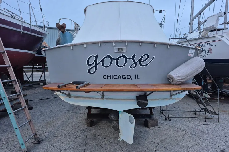 Slide: The Image of 1986 Dyer 29 Trunk Cabin boat named "Goose" in Chicago, IL, docked on land. - 33