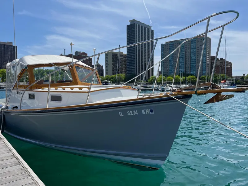 Slide: The Image of 1986 Dyer 29 Trunk Cabin boat docked in urban marina with city skyline. - 4