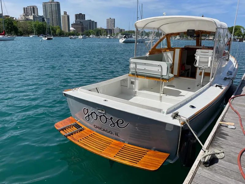 Slide: The Image of 1986 Dyer 29 Trunk Cabin boat docked in Chicago marina, sunny day. - 5
