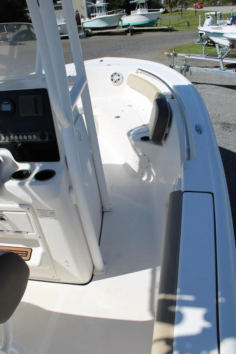 Slide: The Image of 2019 Tidewater 210 CC Adventure boat interior, featuring console and seating area. - 11