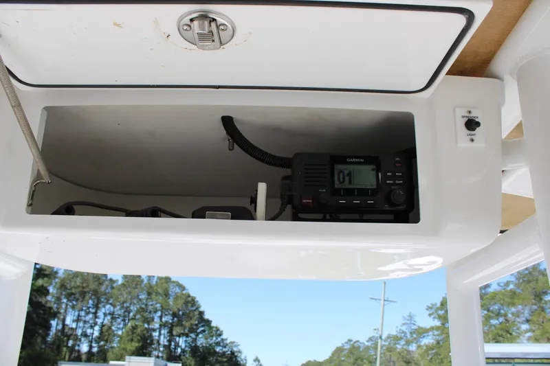 Slide: The Image of 2019 Tidewater 210 CC Adventure boat console with radio equipment. - 13