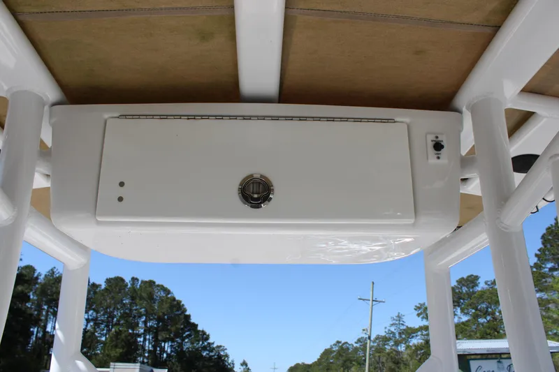 Slide: The Image of 2019 Tidewater 210 CC Adventure boat console, viewed from below, with clear blue sky. - 14