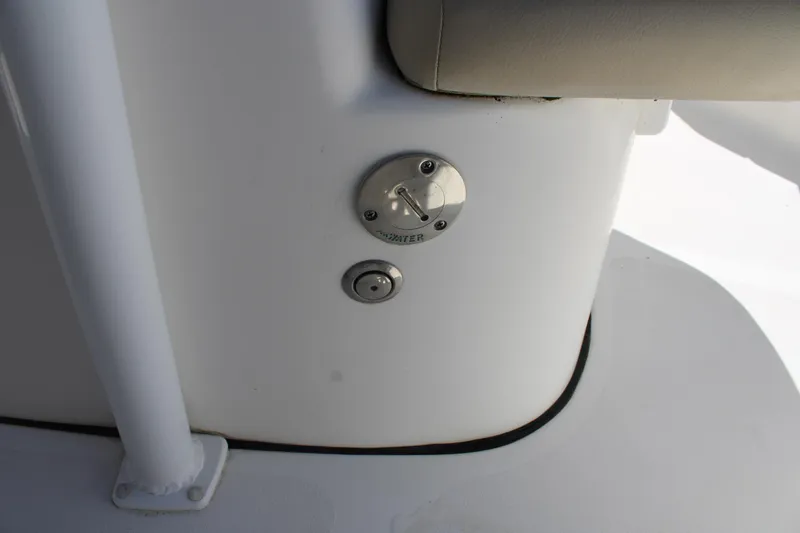 Slide: The Image of 2019 Tidewater 210 CC Adventure boat detail showing a fuel cap and seating area. - 20