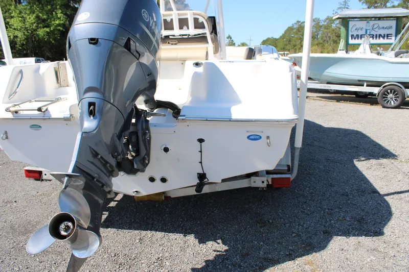 Slide: The Image of 2019 Tidewater 210 CC Adventure boat with outboard motor, parked on a trailer. - 23