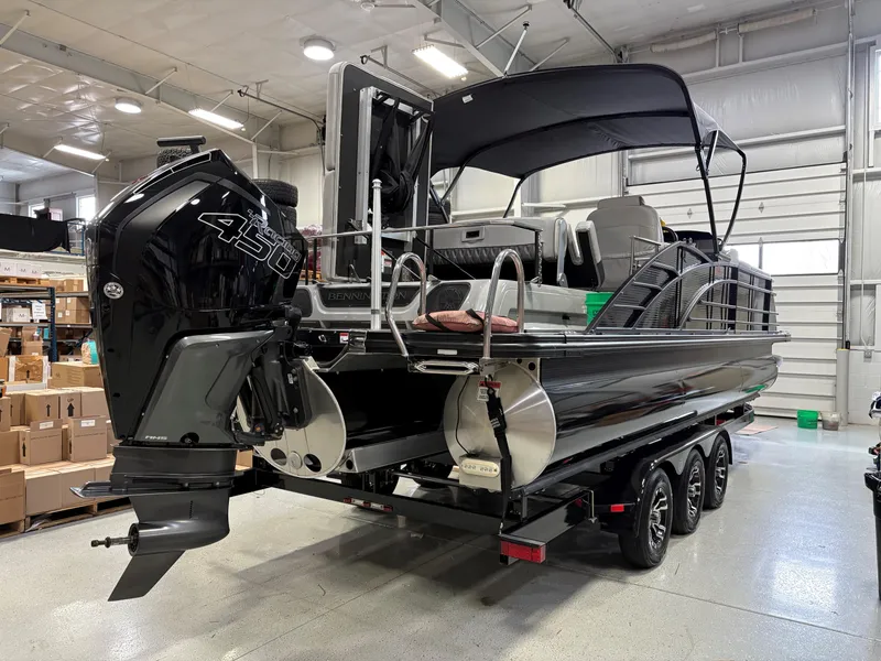 Slide: The Image of 2022 Bennington 25 QSBSG pontoon boat with powerful 450 engine in a showroom. - 2