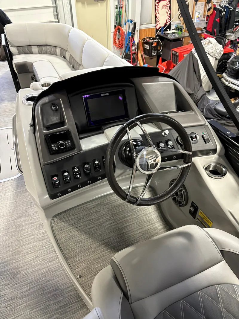 Slide: The Image of 2022 Bennington 25 QSBSG boat interior with modern dashboard and steering wheel. - 6